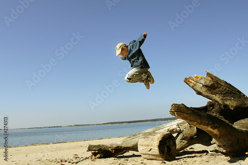 jumping boy on the spring beach