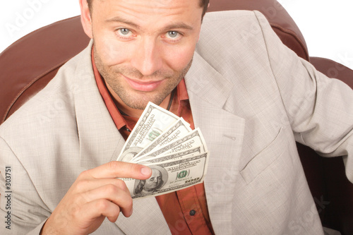 smiling man with few houndred dollars bills in the