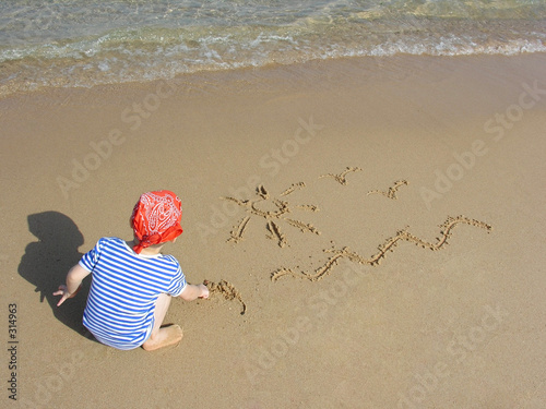 boy draw on beach photo