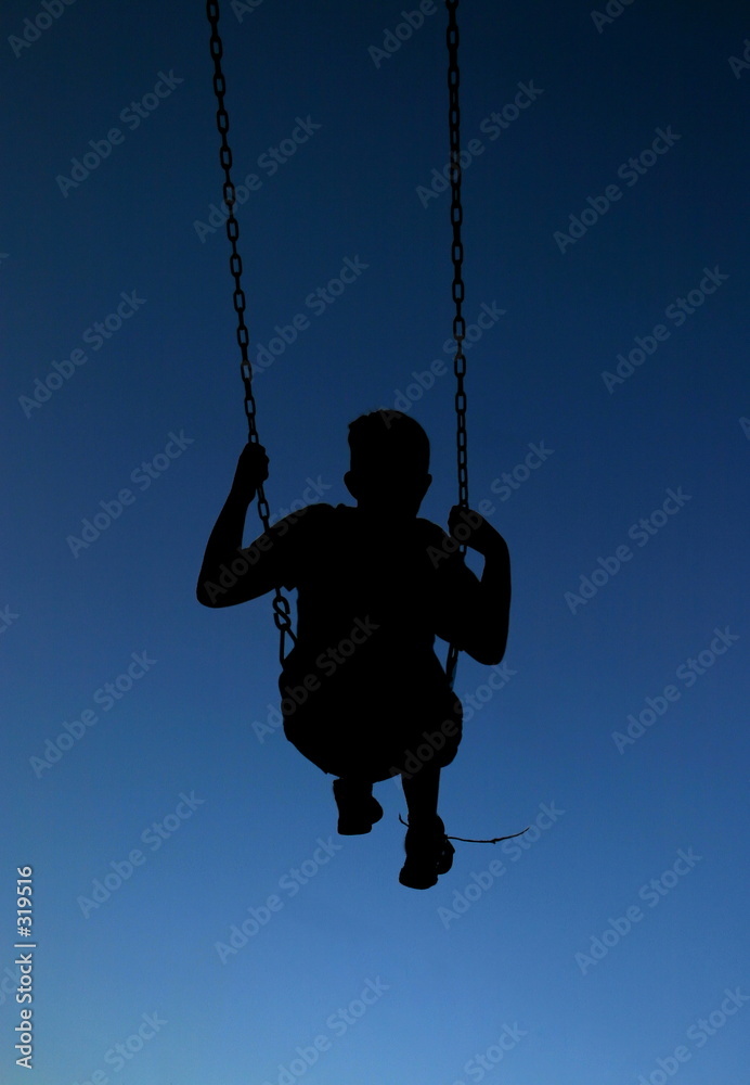 silhouette child on swings.