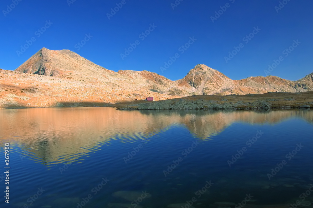 mountain range with its reflection in the nearby g