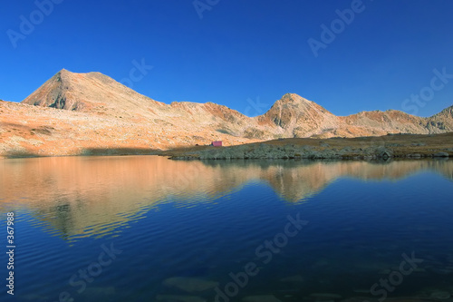 mountain range with its reflection in the nearby g