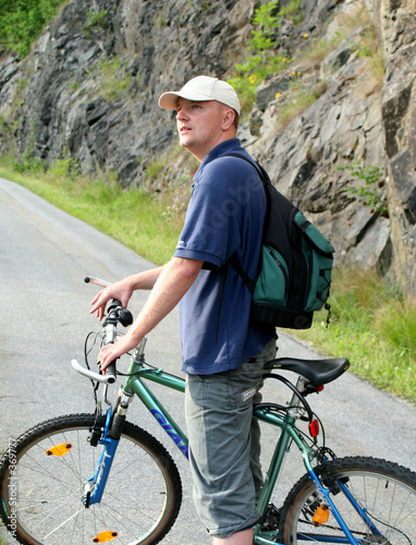 man with bicycle on mountain trip