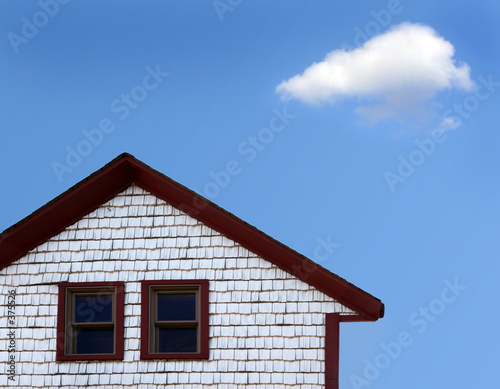 house and blue sky with cloud © Galina Barskaya
