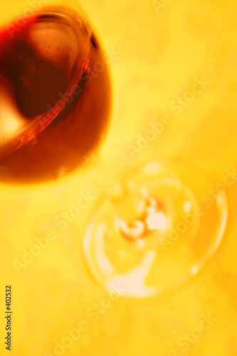 blurred red wine glass on yellow