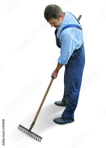 Fotografija gardener  in working clothes, raking garden