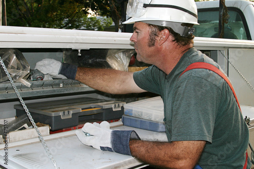 electrician reaches in service truck photo