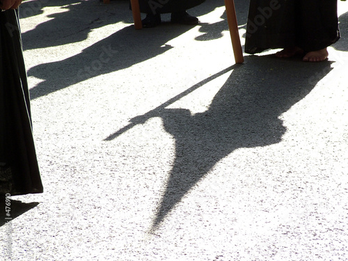 sombra y silueta de un nazareno en la semana santa de Sevilla photo