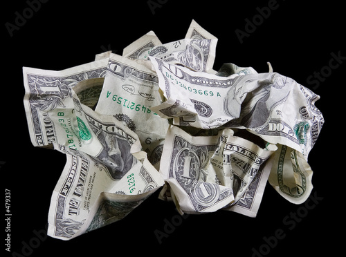 crumpled money on black background