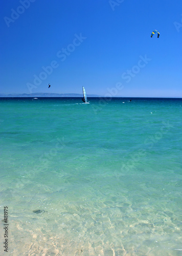Fototapeta Naklejka Na Ścianę i Meble -  waves gently lapping on a white sandy spanish beach in the hot s