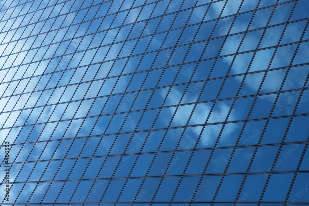 sky reflecting in windows of office building sky reflecting in windows of office building