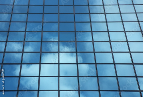 sky reflecting in windows of office building