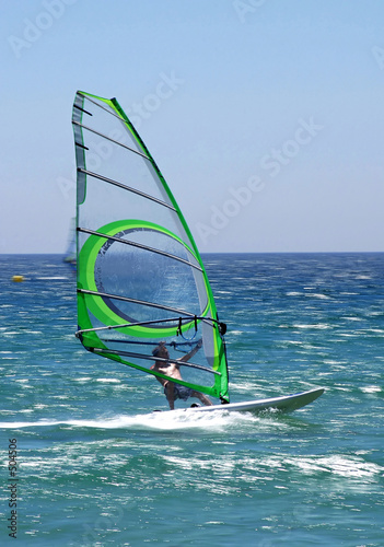 windsurfer on sunny tarifa beach in southern spain