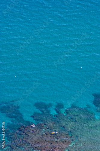aerial view of clear blue water and yellow boat © Nick Stubbs