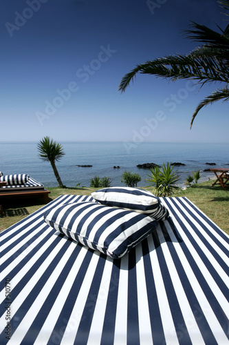 striped sunlounger and sunny sea views