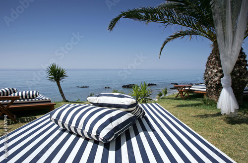 striped sunlounger and sunny sea views