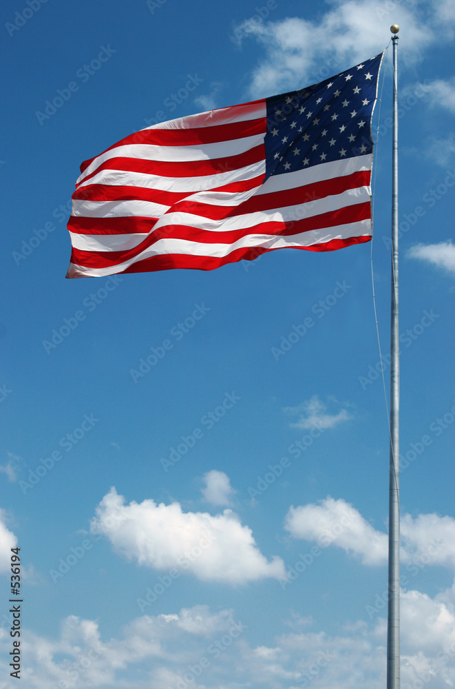 Fototapeta premium large american flag waving in the wind