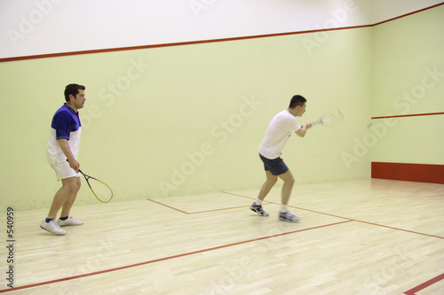 two people playing squash