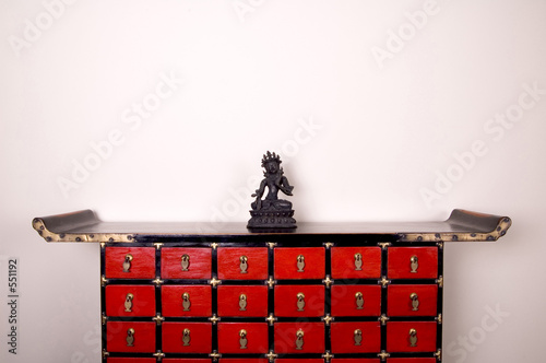 a lamaist diety figurine on a medicine cabinet