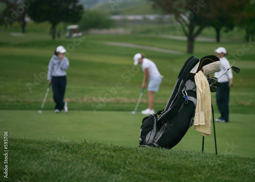 golfers (focus on golf bag)