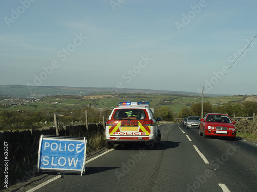 police car and slow sign