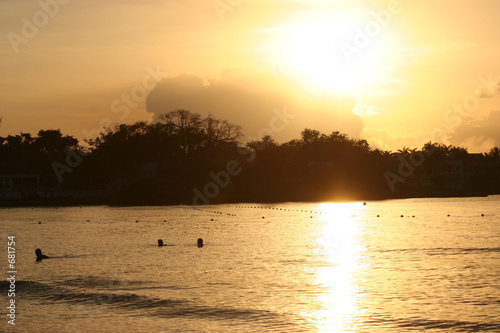beautiful sunset over people swimming in the water © Ben Keith