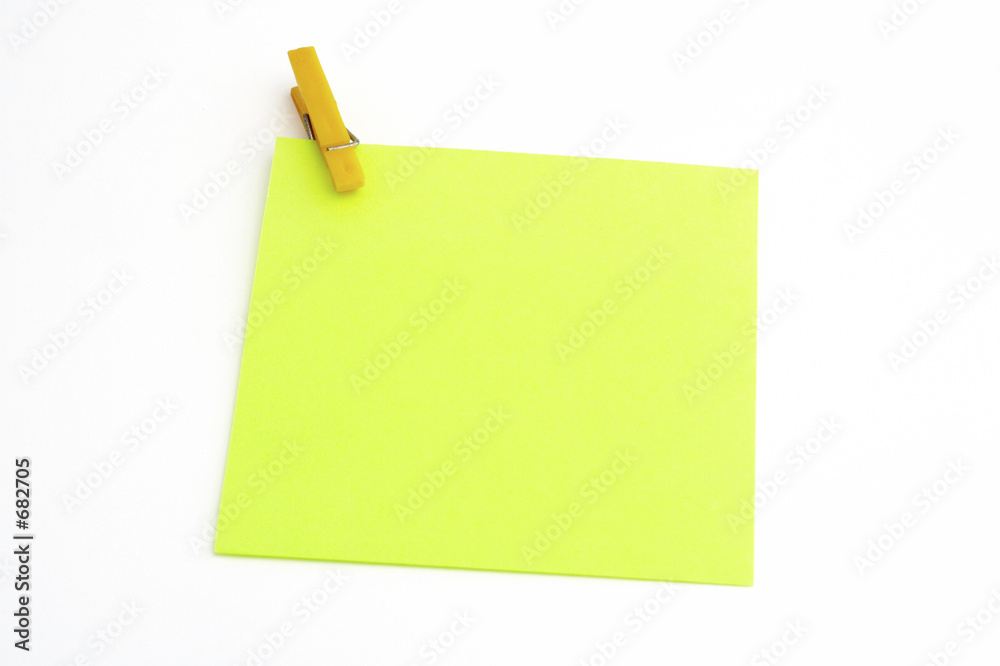 isolated green paper with yellow clamp isolated green paper with yellow clamp