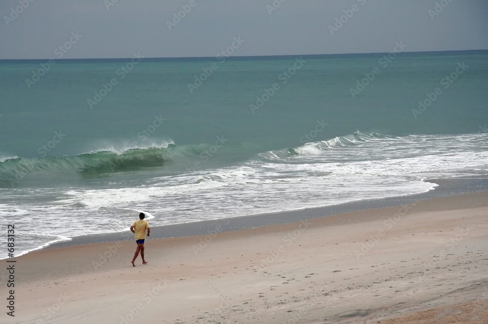 man jogging on the beach