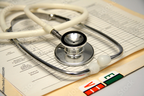 white stethoscope on a medical chart