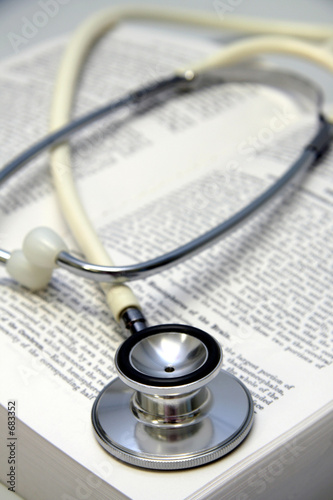 white stethoscope on a medical book