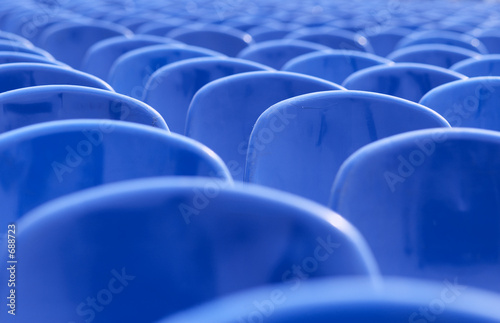 rows of empty blue chairs