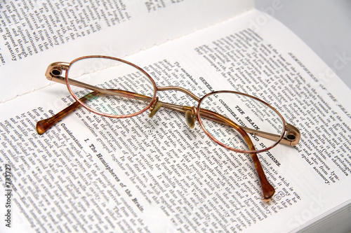 pair of glasses on a medical book