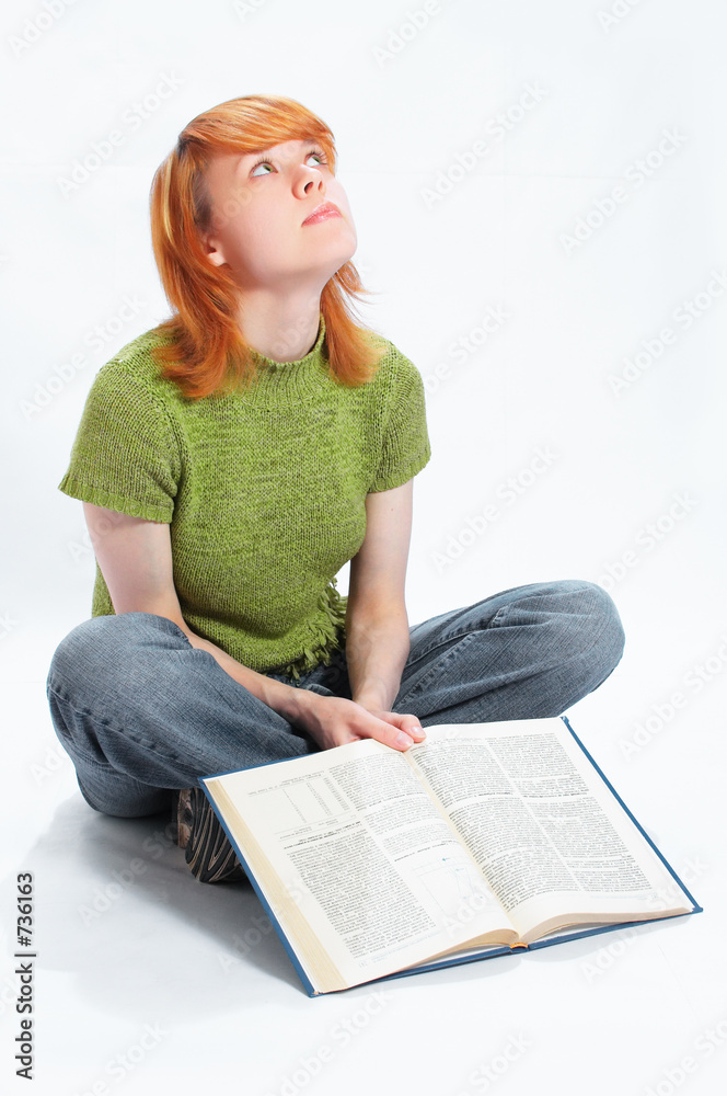 Fotografie young girl read the book on white