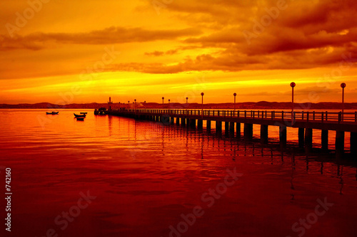 pier and boats at sunset photo