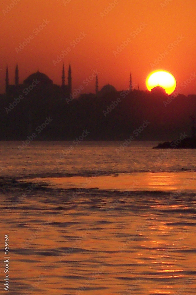 sun behind mosques sun behind mosques