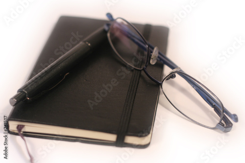pen, diary and glasses - shallow focus