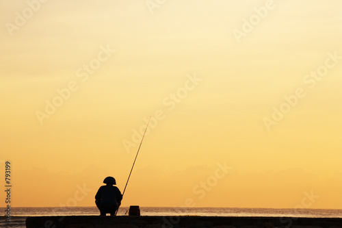 silhouette of fisherman © Creativa Images