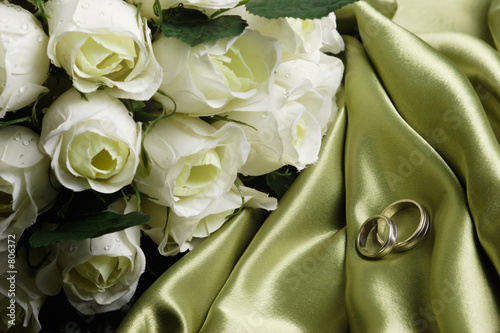 wedding bands on green satin