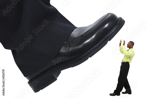 businessman's foot stepping stomping out the compe