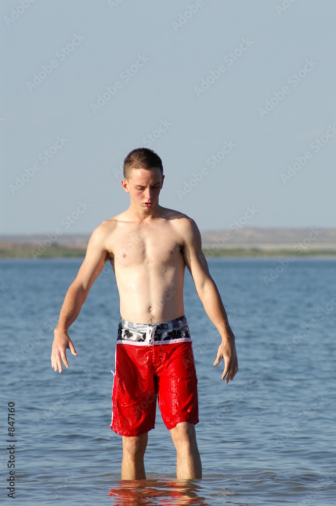 teenage boy leaving lake