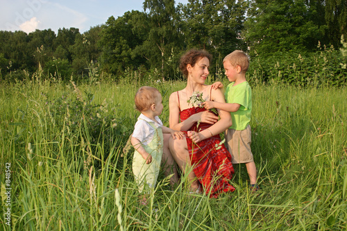 Obraz na plátně children give mother flowers