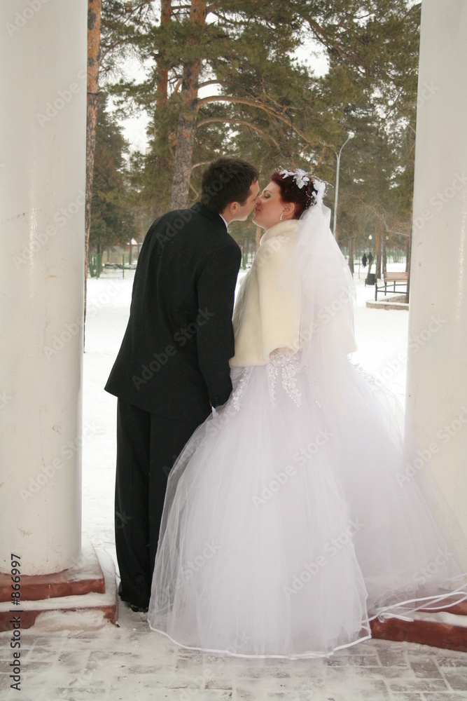 bridegroom and bride are kissed