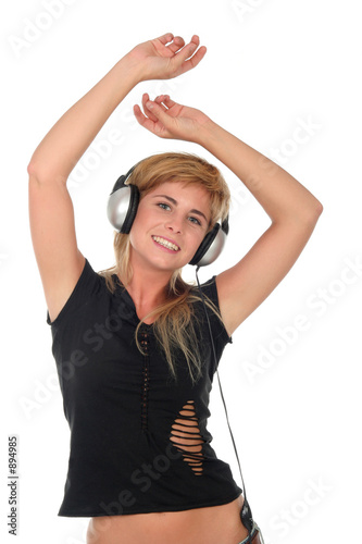 young woman dancing to music in headphones