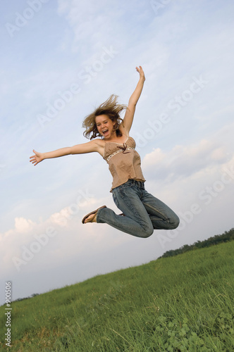 pretty girl leaping in field