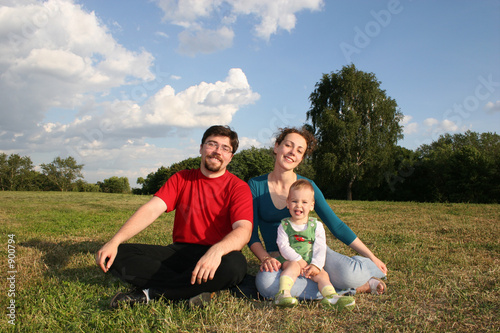 family with baby on meadow and trees 2