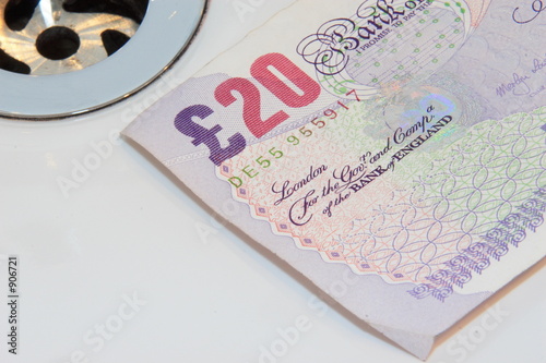 sterling banknote going down the drain