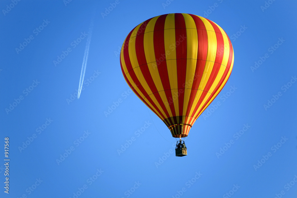 Naklejka premium balloon and an airplane on the blue sky