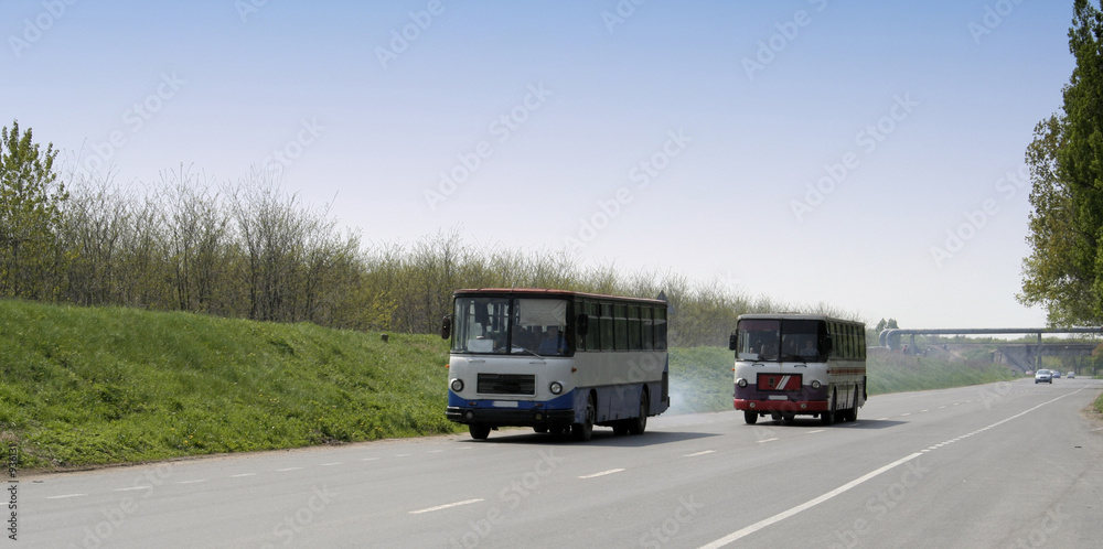 two old busses on the road