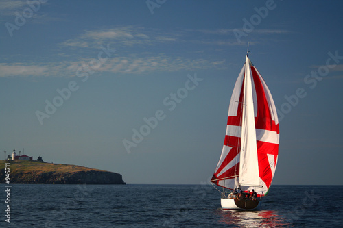 yacht on sunrise near island photo