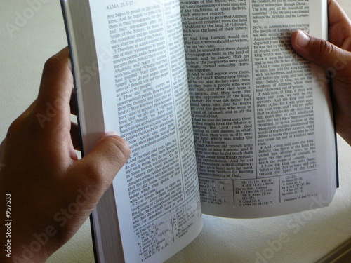 open book of mormon in the hands of a black person photo